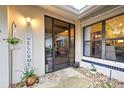 Inviting front entryway with a screened door and hanging plants at 263 Southampton Dr # 301, Venice, FL 34293