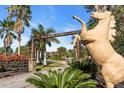 Gated entrance to Tall Palms Ranch with horse statue and palm trees at 3200 Rowland Dr, Punta Gorda, FL 33980