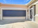 Two-car garage with a retractable sunshade at 5255 Athens Way, Venice, FL 34293
