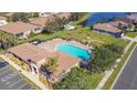 Community pool with plenty of lounge chairs for relaxation at 5255 Athens Way, Venice, FL 34293