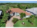 Single-Gathering home with tile roof and manicured lawn at 535 Westmount Ln, Venice, FL 34293