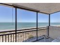 Oceanfront balcony with seating, offering stunning beach and water views at 629 Alhambra Rd # 704, Venice, FL 34285