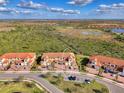 Townhome with a terra cotta colored roof, brick driveway and a large marsh view at 10039 Crooked Creek Dr # 203, Venice, FL 34293