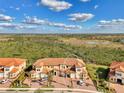 A charming multi-Gathering home boasts a tile roof and lush green landscaping in a sunny, serene setting at 10039 Crooked Creek Dr # 203, Venice, FL 34293