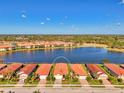 Bird's-eye view of a lakefront home community at 10428 Crooked Creek Dr, Venice, FL 34293