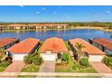 Community of single-Gathering homes centered around a lake at 10428 Crooked Creek Dr, Venice, FL 34293