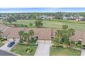 An aerial view showcasing a community with golf course views at 1211 Capri Isles Blvd # 58, Venice, FL 34292