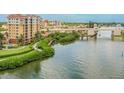 Waterfront condos located along a scenic river, with lush landscaping and nearby bridge at 157 Tampa E Ave # 807, Venice, FL 34285
