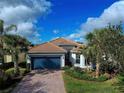 Single-story house with tile roof, driveway and nicely landscaped yard at 19279 Jacinda St, Venice, FL 34293