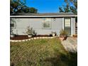 Charming single-story home featuring a well-manicured lawn and decorative potted plants at 2191 Park Rd, Venice, FL 34293