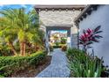 Stone walkway leading to home with tropical landscaping at 245 Corelli Dr, Nokomis, FL 34275