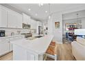 Well-lit open kitchen featuring an island with seating, and stainless steel appliances at 26069 Norman Dr, Englewood, FL 34223