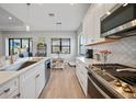 Bright kitchen with a breakfast nook, stainless steel appliances, and lots of counter space at 26069 Norman Dr, Englewood, FL 34223