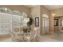 Bright dining room featuring glass table, wicker chairs, and large window at 275 Royal Oak Way, Venice, FL 34292