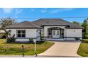 White house with gray accents and a paved driveway at 3436 Santa Clara Dr, Punta Gorda, FL 33983