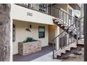 Stairs leading to the entrance of a two-story condo with decorative planters at 380 Three Lakes Ln # E, Venice, FL 34285