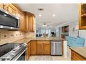Remodeled kitchen with stainless steel appliances, granite countertops, and ample wood cabinetry at 380 Three Lakes Ln # E, Venice, FL 34285