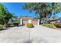 Two-car garage with driveway and mature trees at 4417 Park Lake N Ter, Bradenton, FL 34209