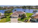 Stunning aerial view of a waterfront home in a peaceful community with solar panels at 5372 Oakmont Ct, North Port, FL 34287