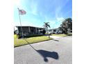 Two manufactured homes on a sunny street with palm trees at 73 Lakeview Dr, North Port, FL 34287