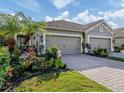 Two-car garage and nicely landscaped front yard at 1195 Collier Pl, Venice, FL 34293