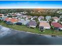 Panoramic aerial community view with picturesque waterfront homes by the lake under a bright blue sky at 1307 Highland Greens Dr, Venice, FL 34285