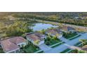 Houses with tile roofs near a lake and conservation area at 13389 Caravaggio Ct, Venice, FL 34293