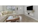 Living Room with sectional sofa and a modern TV stand at 13540 Dibella Ave, Port Charlotte, FL 33981