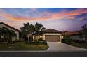 House exterior view at dusk with palm trees at 287 Cassano Dr, Nokomis, FL 34275