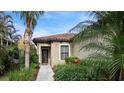 Front entry of home with walkway and landscaping at 287 Cassano Dr, Nokomis, FL 34275
