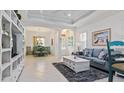 Bright living room with gray sofa and built in shelving at 287 Cassano Dr, Nokomis, FL 34275