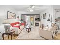 Bright living room with white couch, fireplace, and hardwood floors at 4160 Fruitville Rd # 14, Sarasota, FL 34232