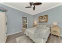 Cozy bedroom with wood flooring, ceiling fan, and en-suite bathroom at 9855 Haze Dr, Venice, FL 34292