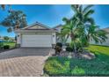 Single story home with white garage door and landscaping at 11679 Anhinga Ave, Venice, FL 34292
