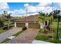 Two-story home with two-car garage and mature landscaping at 12313 Amica Loop, Venice, FL 34293