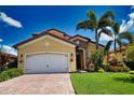 Exterior view of a single-Gathering home with a large driveway and landscaping at 140 Maraviya Blvd, Nokomis, FL 34275
