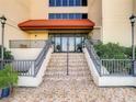 Condo building entrance with tiled stairs at 21405 Olean Blvd # 404, Port Charlotte, FL 33952