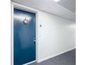 Condo hallway with blue apartment door at 21405 Olean Blvd # 404, Port Charlotte, FL 33952