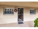 Inviting condo entry with a wreath and neutral color scheme at 2260 Stickney Point Rd # 303, Sarasota, FL 34231
