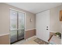 Bright entryway with white door and window with blinds at 324 Wexford Ter # 171, Venice, FL 34293