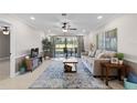 Living room with tiled floors, couch, and view of patio at 324 Wexford Ter # 171, Venice, FL 34293