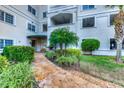 Landscaped entryway with a stone path leading to the building entrance at 3730 Cadbury Cir # 400, Venice, FL 34293