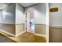 Building hallway with beige walls and carpet, showing condo unit entrance at 3730 Cadbury Cir # 400, Venice, FL 34293