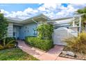 Front entry of the house with lush landscaping and a walkway at 452 Wexford Cir # 105, Venice, FL 34293