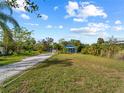 Blue house with a large yard, perfect for outdoor activities at 4533 Church St, Punta Gorda, FL 33980