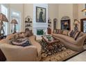 Elegant living room with a decorative fireplace, plush seating, and high ceilings at 457 Anchorage Dr, Nokomis, FL 34275