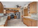 Bright kitchen with oak cabinets, stainless steel appliances, and tile flooring at 508 Foxwood Blvd, Englewood, FL 34223