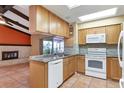 Kitchen boasts granite countertops, wood cabinets, and tile floors at 5221 Lemon Bay Dr, Venice, FL 34293