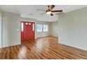 Living room featuring hardwood floors and a red front door at 5221 Lemon Bay Dr, Venice, FL 34293