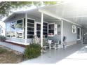 Gray mobile home with covered porch and welcoming decor at 727 Blackburn Blvd, North Port, FL 34287